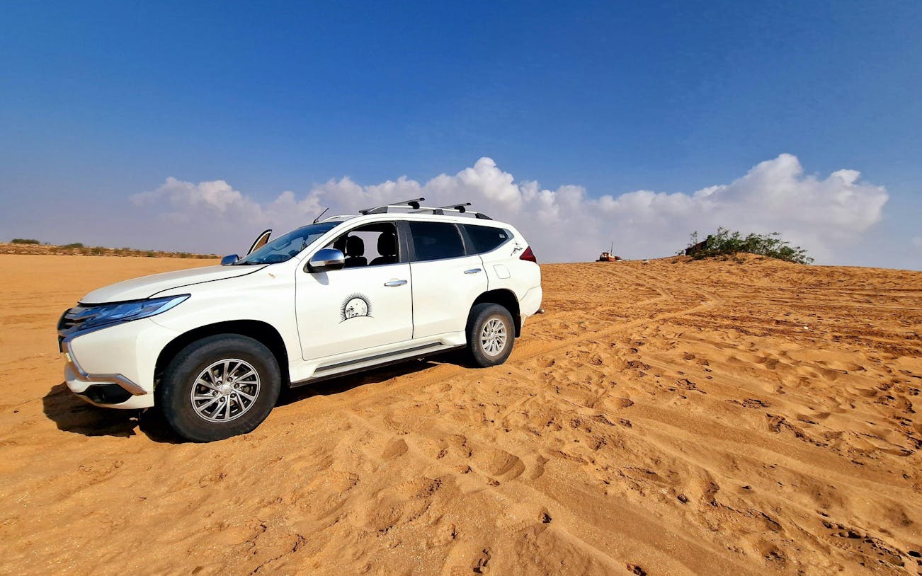 4x4 vehicle on Sahara Desert sand dunes, Agadir adventure tour.
