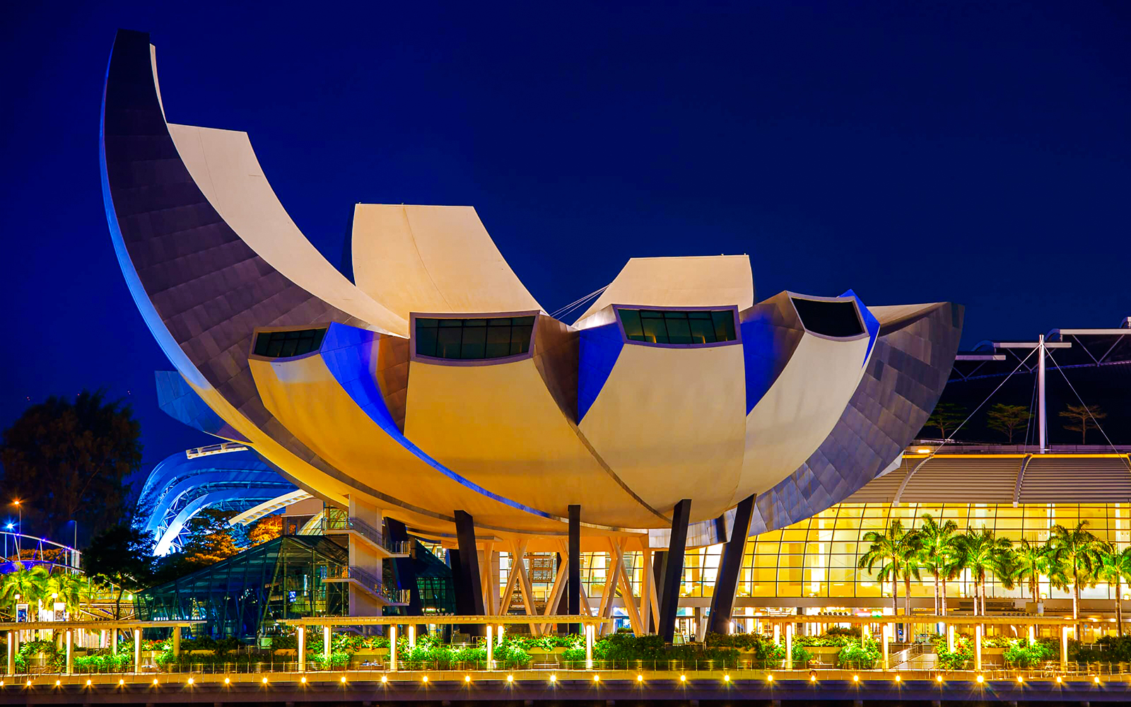 ArtScience Museum in Singapore at dusk, lit with blue lights.