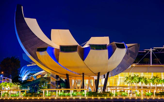 ArtScience Museum in Singapore at dusk, lit with blue lights.
