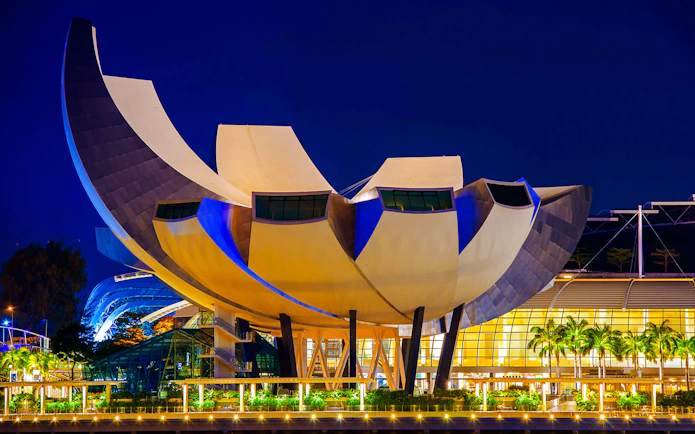 ArtScience Museum in Singapore at dusk, lit with blue lights.