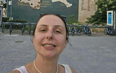 Selfie in front of historical map mural and bike station, Constanta city exploration game.