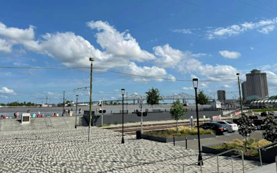 Riverfront view with Crescent City Connection bridge in New Orleans French Quarter.