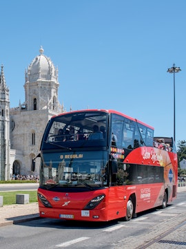 Lisbon sightseeing bus near Jerónimos Monastery on hop-on hop-off tour.