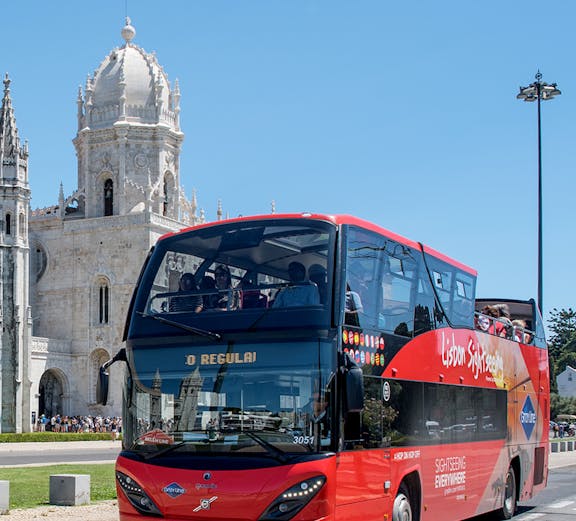 Lisbon sightseeing bus near Jerónimos Monastery on hop-on hop-off tour.