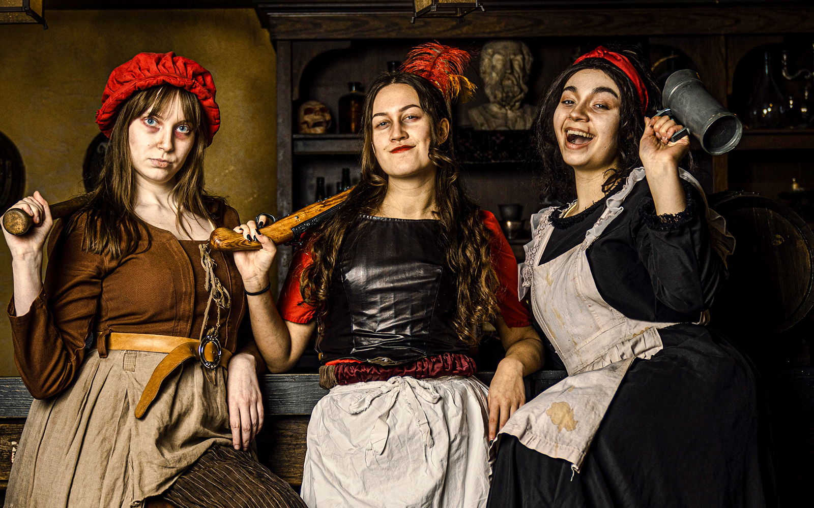 Guests in historical costumes at the Amsterdam Dungeon experience.