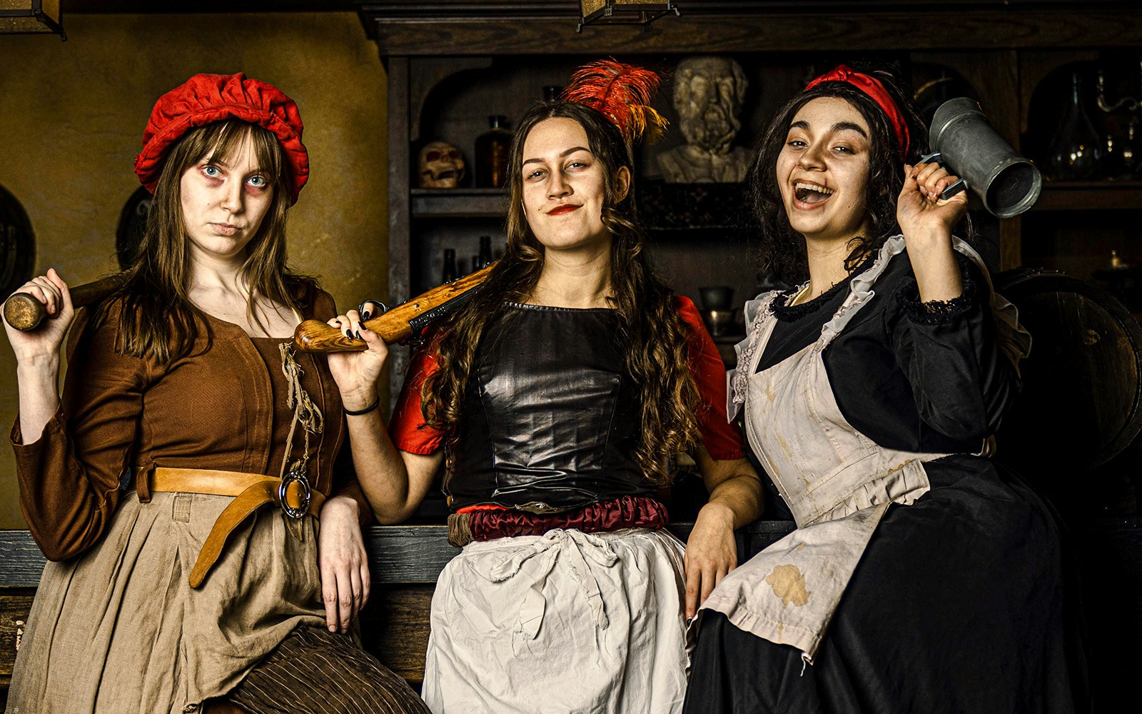 Guests in historical costumes at the Amsterdam Dungeon experience.