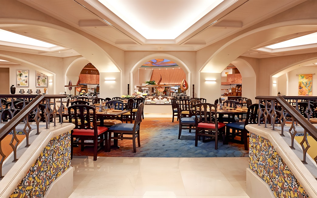 Dining area at Kaleidoscope restaurant, Atlantis Dubai, featuring elegant seating and buffet setup.