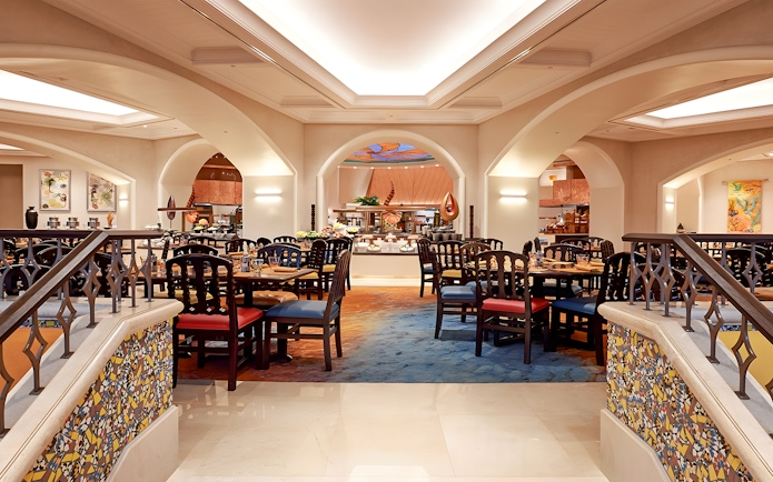 Dining area at Kaleidoscope restaurant, Atlantis Dubai, featuring elegant seating and buffet setup.