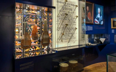 Musical instruments and historical documents displayed at Lobkowicz Palace Museum, Prague.