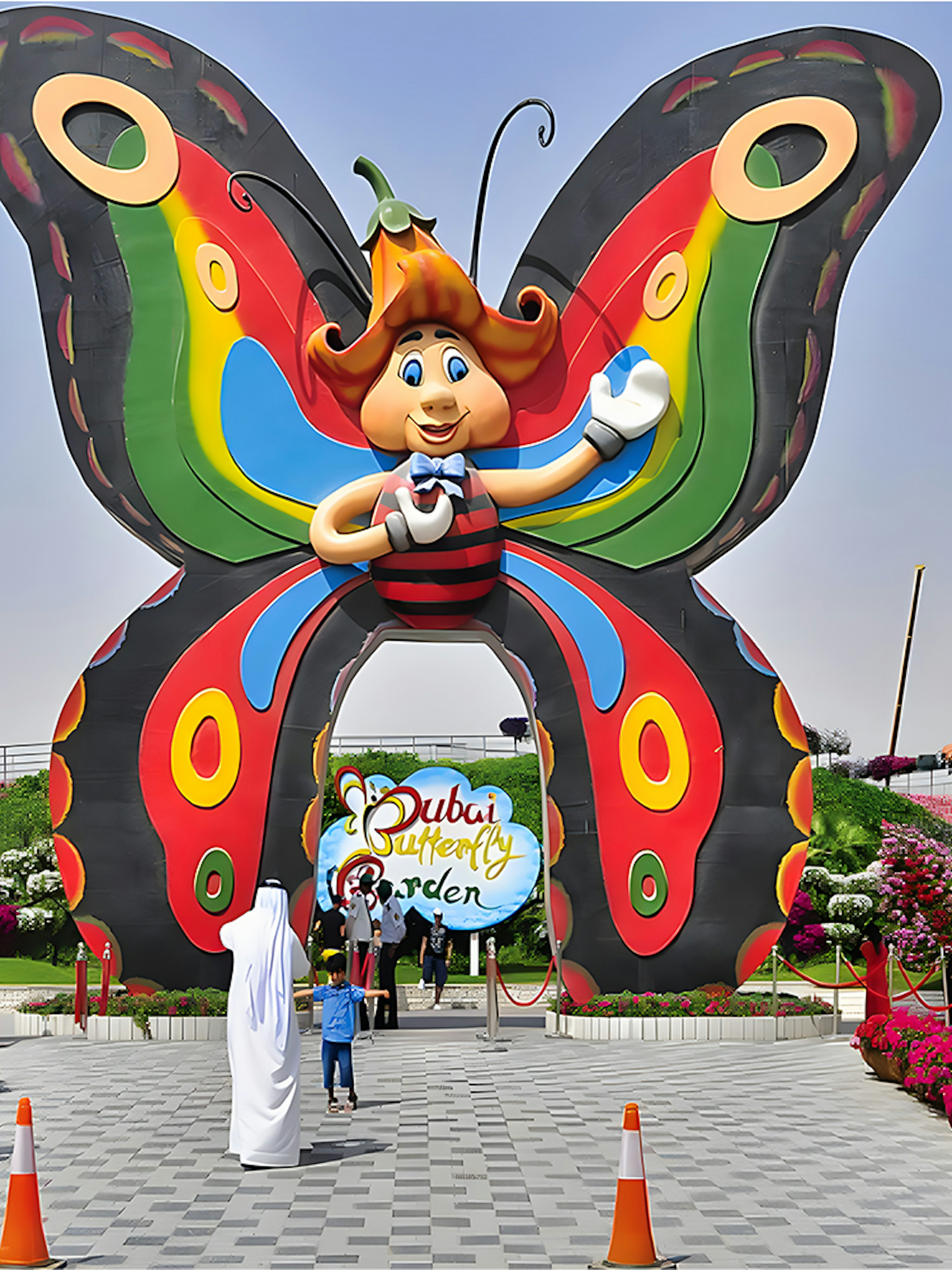 Entrance to Dubai Butterfly Garden with colorful butterfly arch and visitors.