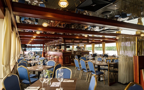 Dining area of MS Kaiserin Elisabeth with tables set for guests.