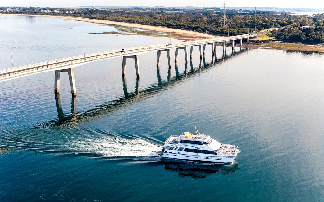 Cruise boat near bridge on Cape Woolamai coastline, Phillip Island.