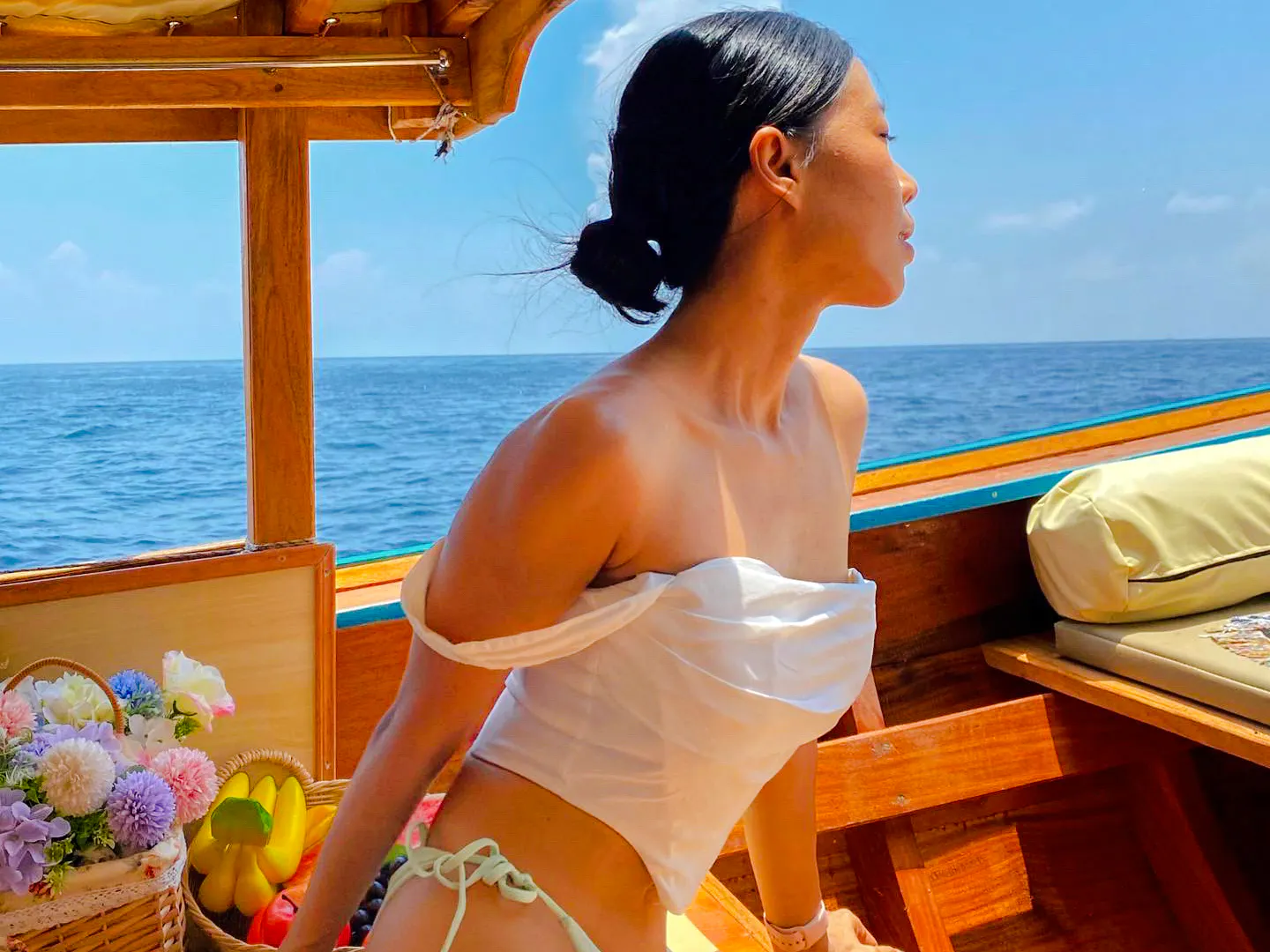 Longtail boat ride to Maya Bay, Krabi with ocean view and flowers.