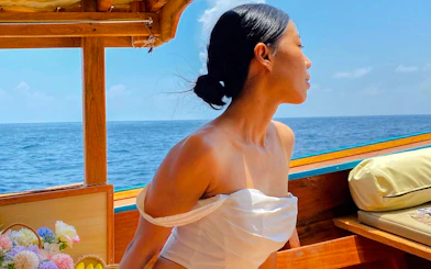 Longtail boat ride to Maya Bay, Krabi with ocean view and flowers.