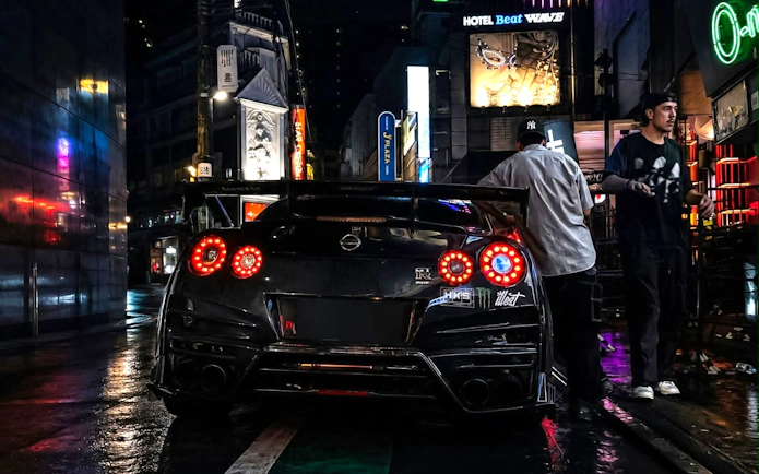 Nissan GT-R parked on Tokyo street during JDM culture tour with Liberty Walk and Daikoku PA.