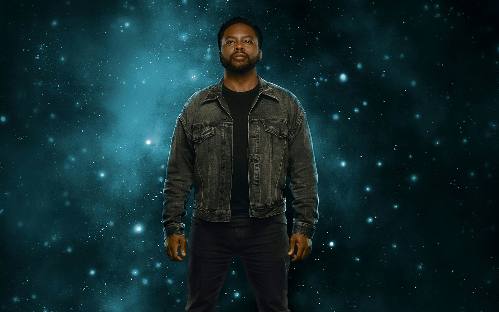 Man standing against a starry background, related to "X: The Life and Times of Malcolm X.