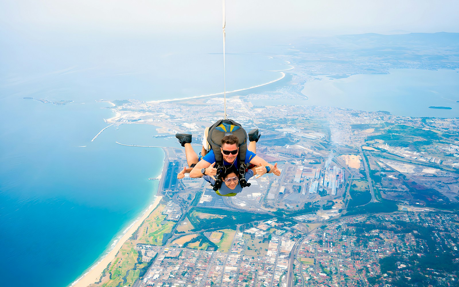A guest and an instructor skydiving over Wollongong