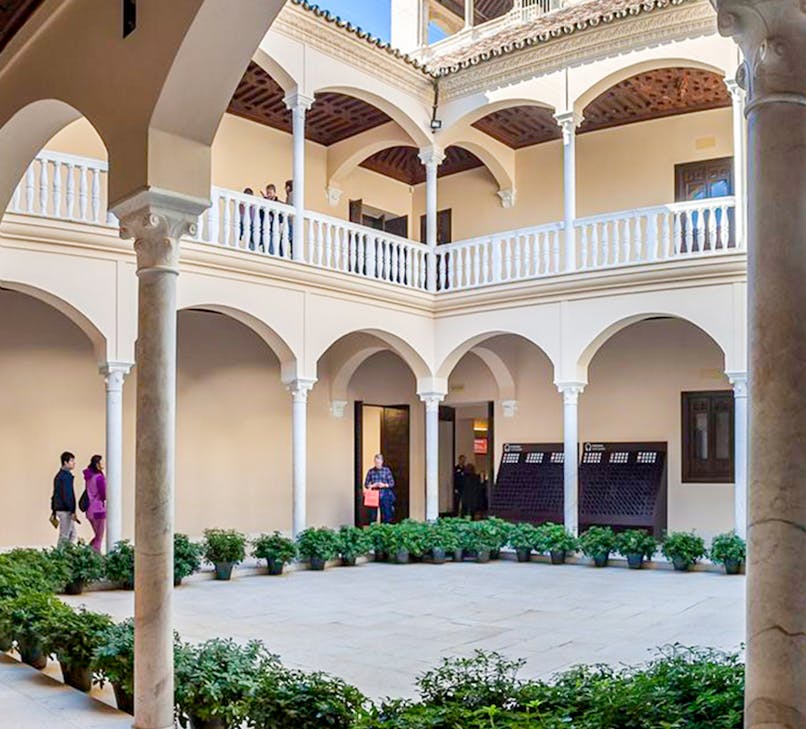 Courtyard of the Picasso Museum in Malaga with historic architecture and lush greenery.