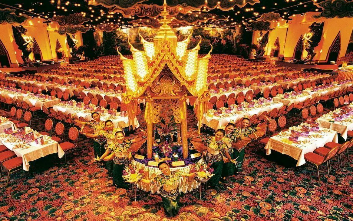 Phuket FantaSea Show dining hall with performers in traditional attire.