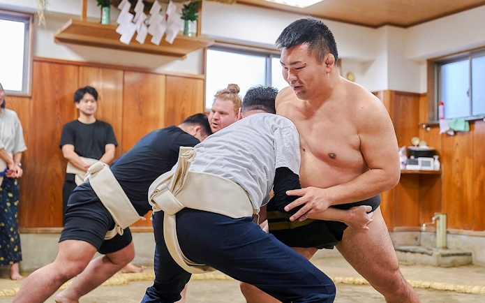 Sumo wrestlers practicing in a Koto City dojo.