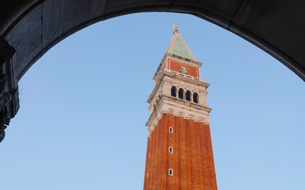 Bell tower of St. Mark's Basilica viewed through archway, Venice, Italy.