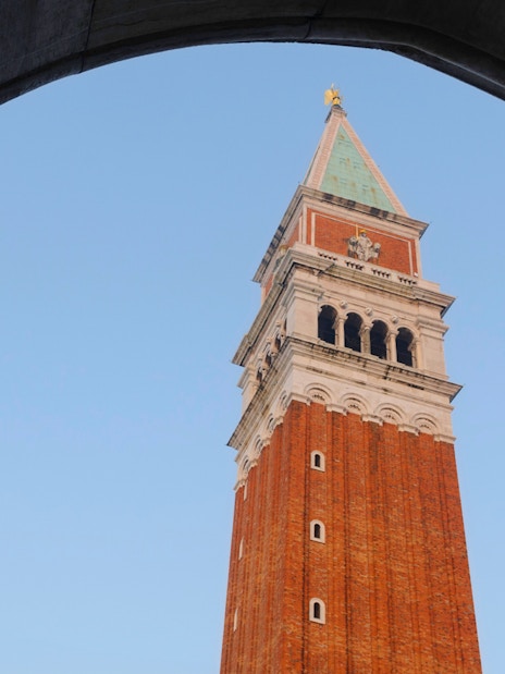 Bell tower of St. Mark's Basilica viewed through archway, Venice, Italy.