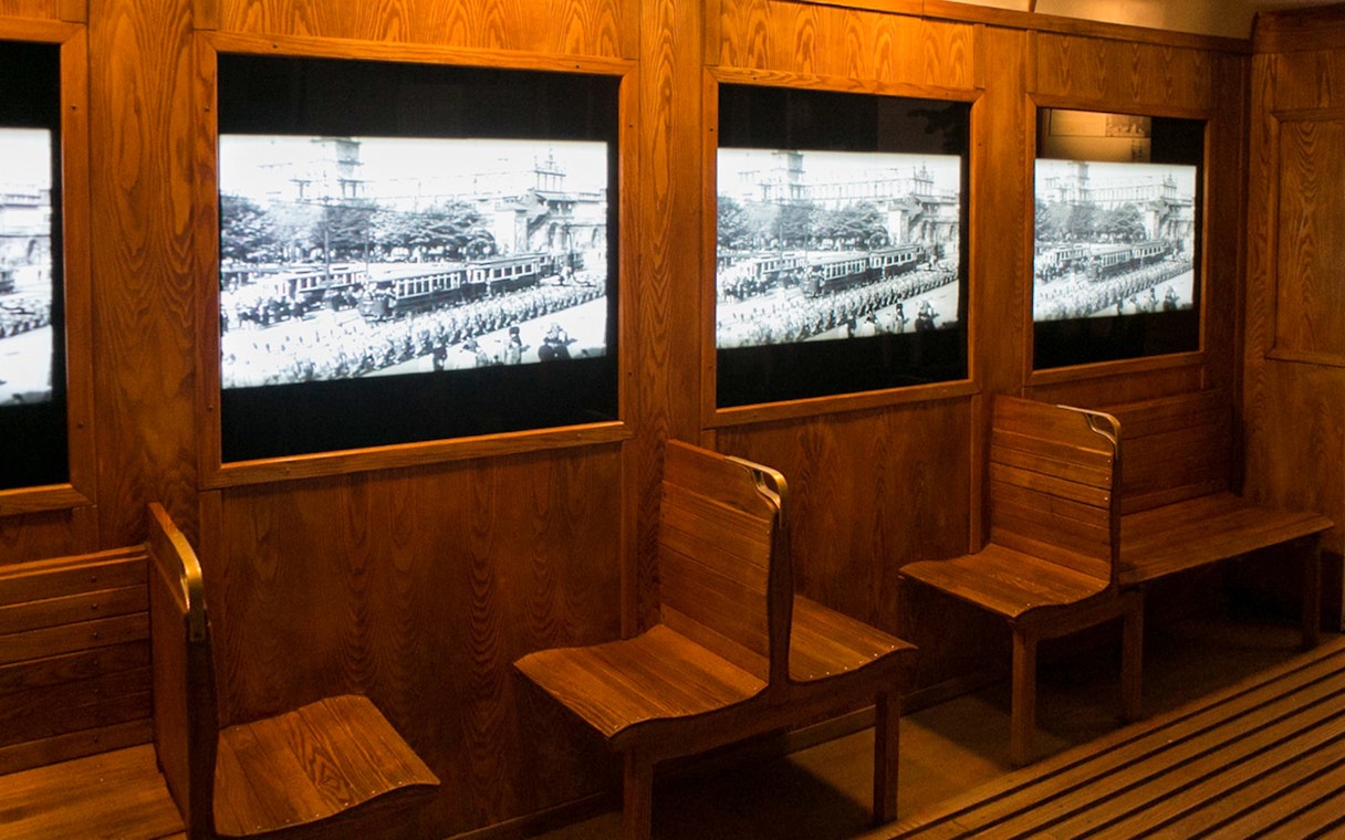 Wooden benches and historical displays at Schindler's Factory, Krakow tour.