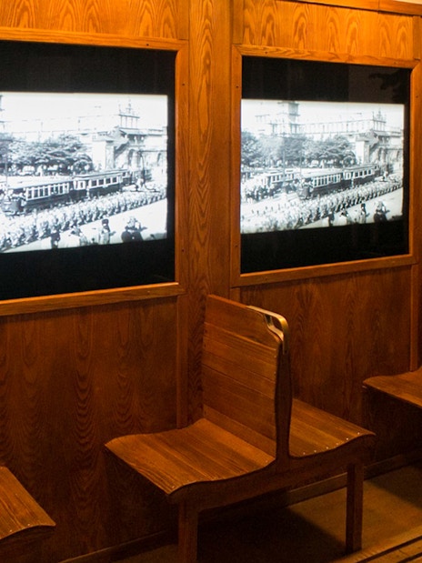 Wooden benches and historical displays at Schindler's Factory, Krakow tour.