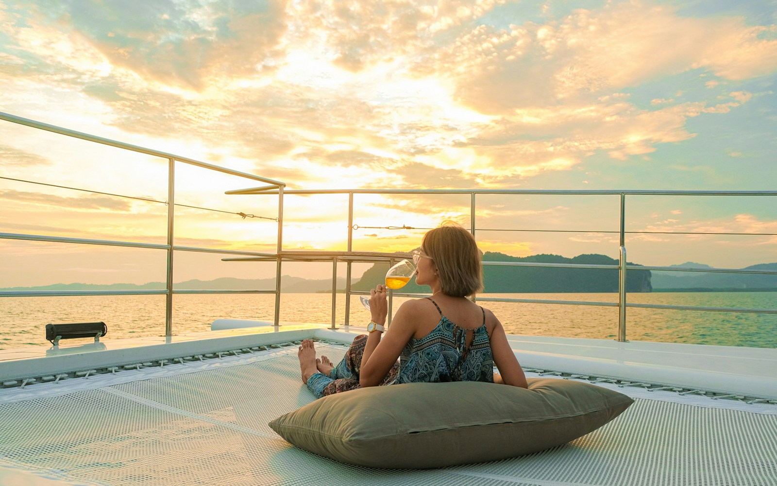 Woman enjoying sunset on yacht deck during James Bond tour from Phuket.