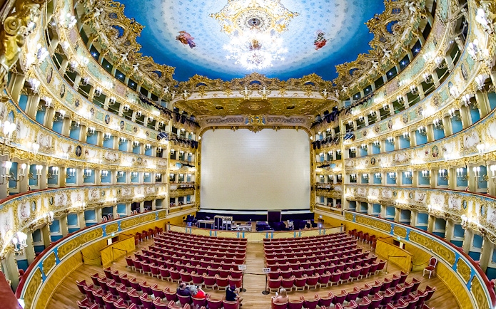 Fenice Theater interior with ornate balconies and stage, Venice, Italy.