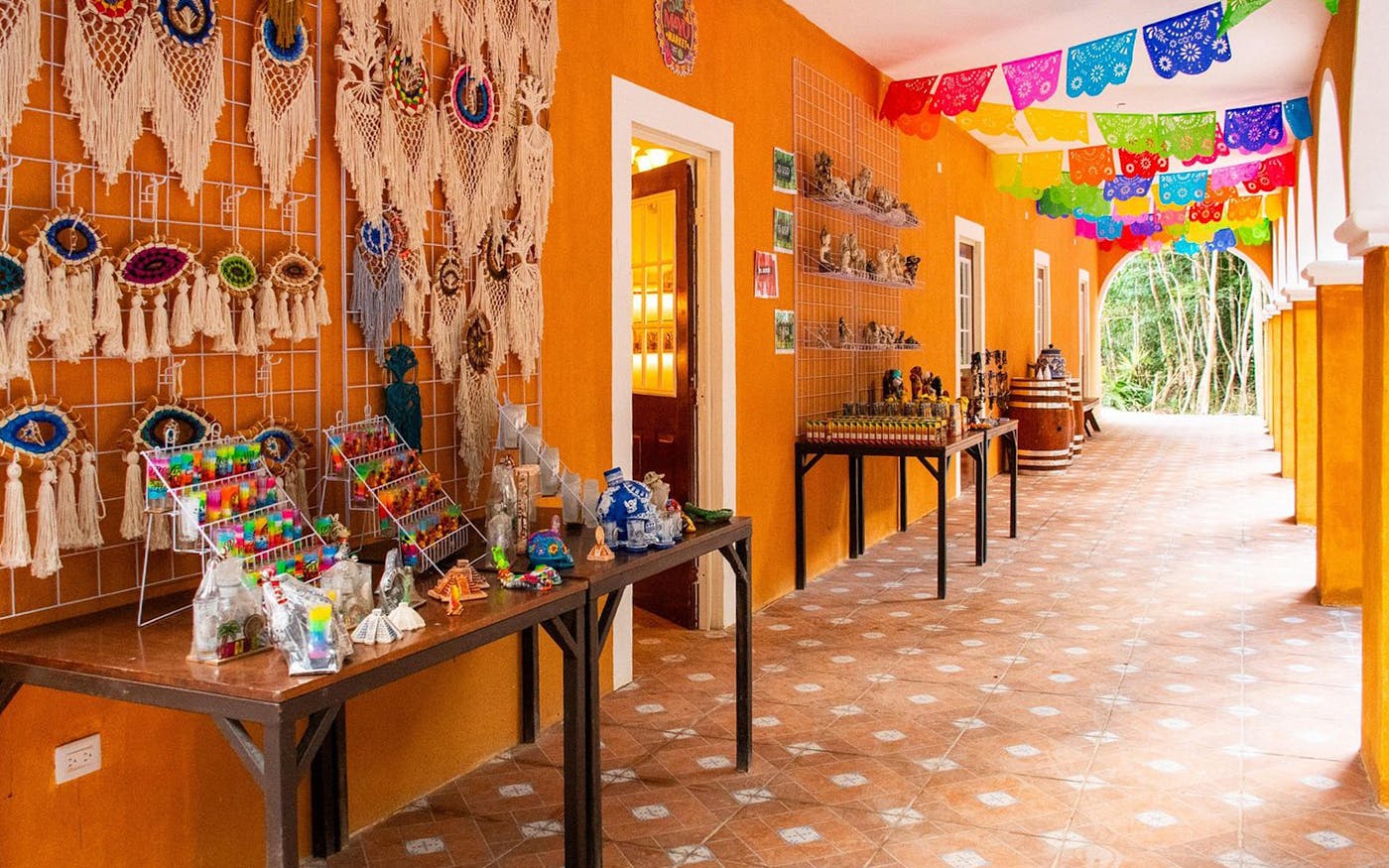 Handicrafts displayed in a vibrant corridor during Cancun Jungle Adventure tour.