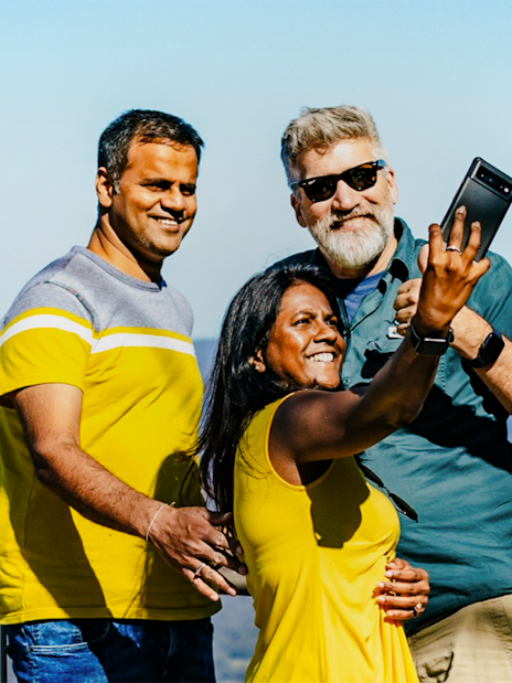 Guests taking a selfie at Boroka Lookout with mountain views in the background.