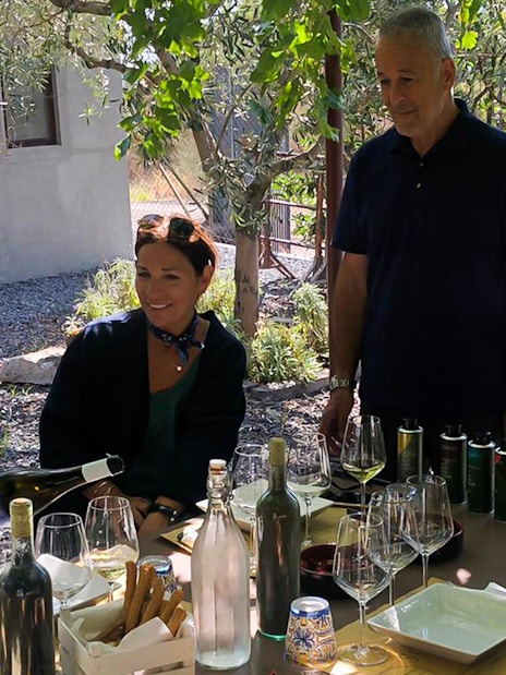 Group enjoying wine and olive oil tasting at Mount Etna tour.