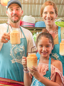 Family enjoying drinks at Mama Noi Cooking Classes in Thailand.