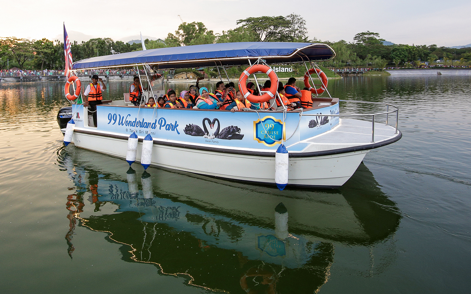 Boat tour at 99 Wonderland Park with passengers wearing life jackets.