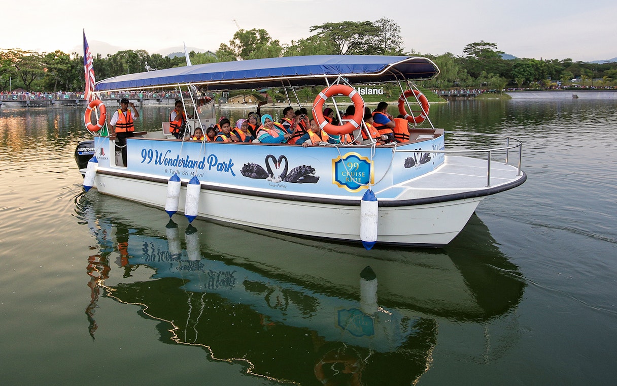 Boat tour at 99 Wonderland Park with passengers wearing life jackets.