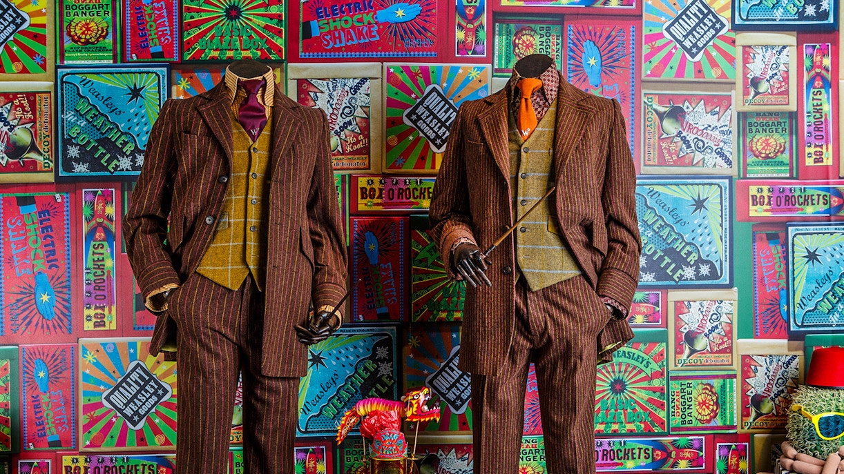 Weasley twins' suits and joke products at the magical mischief exhibit, Harry Potter London tour.