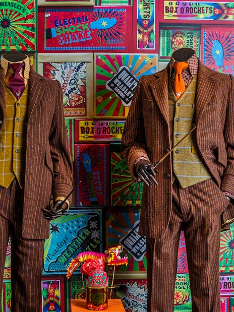 Weasley twins' suits and joke products at the magical mischief exhibit, Harry Potter London tour.