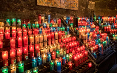 Colorful candles lit inside Montserrat Monastery, Spain.