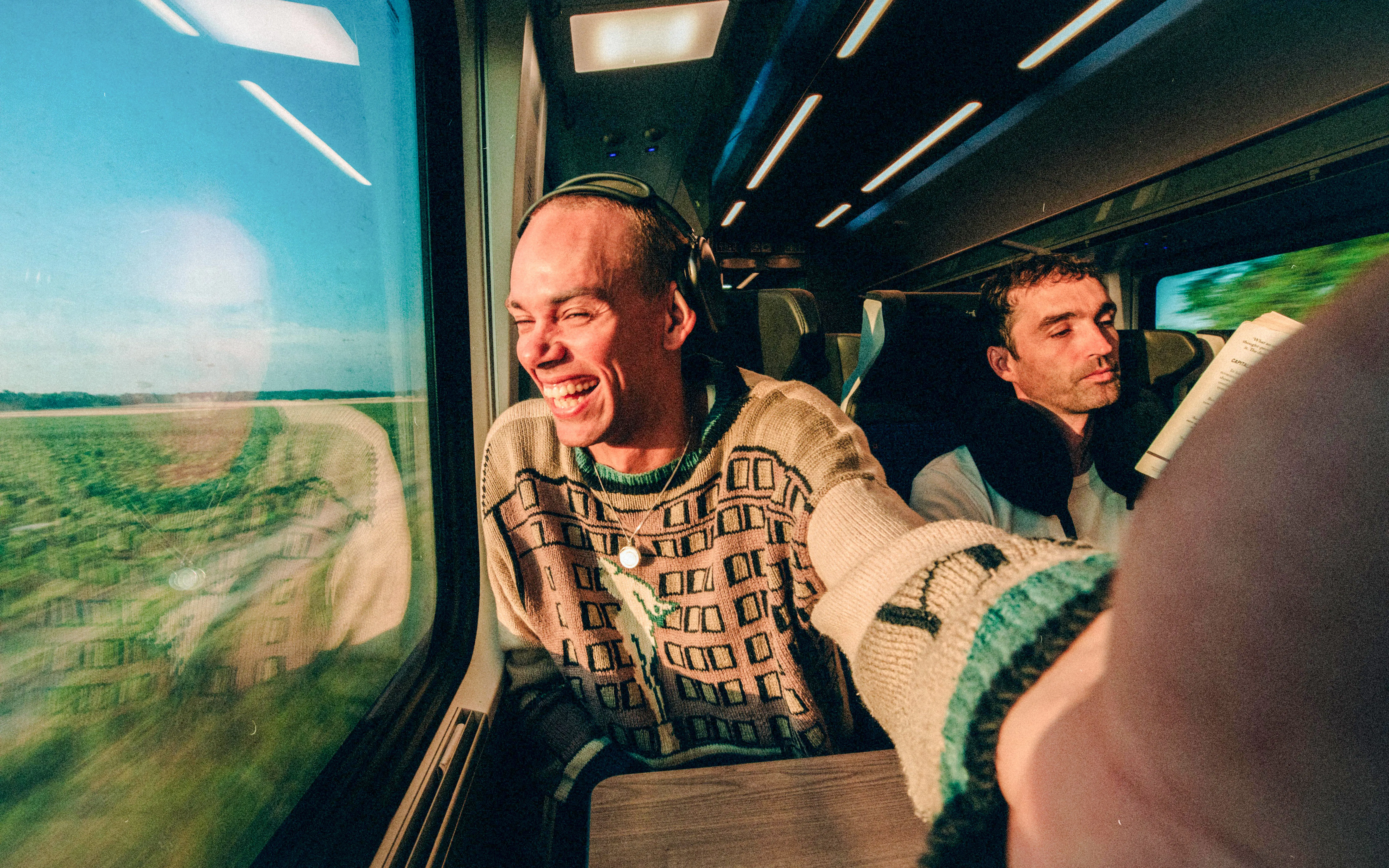 Travelers enjoying scenic views on a train with Interrail Global Continuous Pass.