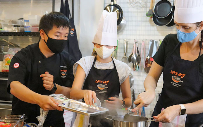 Chef guiding participants in a cooking class during a Market to Table Culinary Tour.