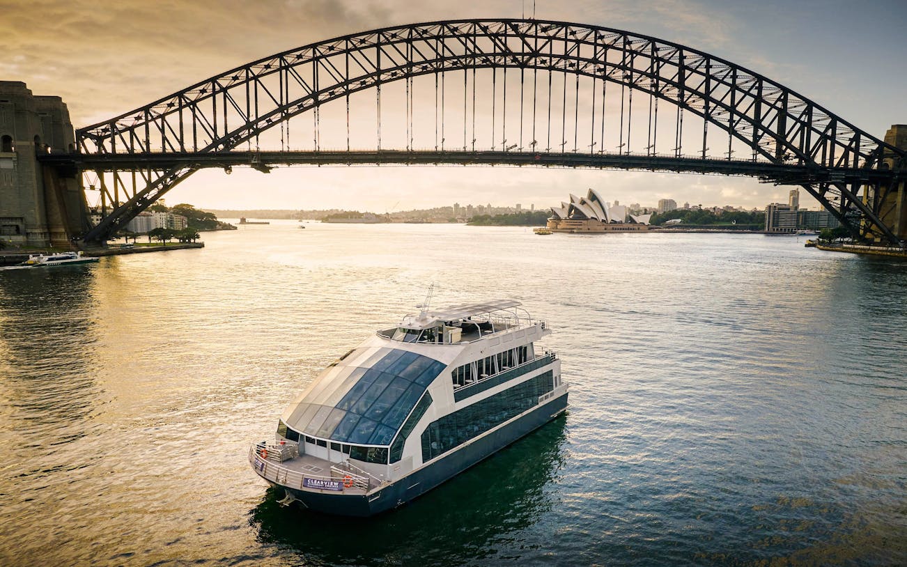 Cruise ship on Sydney Harbour with views of the Harbour Bridge and Opera House.