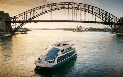 Cruise ship on Sydney Harbour with views of the Harbour Bridge and Opera House.