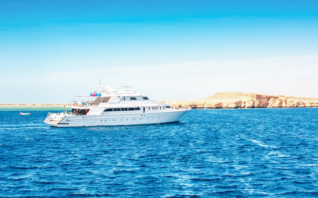 Luxury yacht cruising near White Island, Sharm El-Sheikh, with clear blue waters.