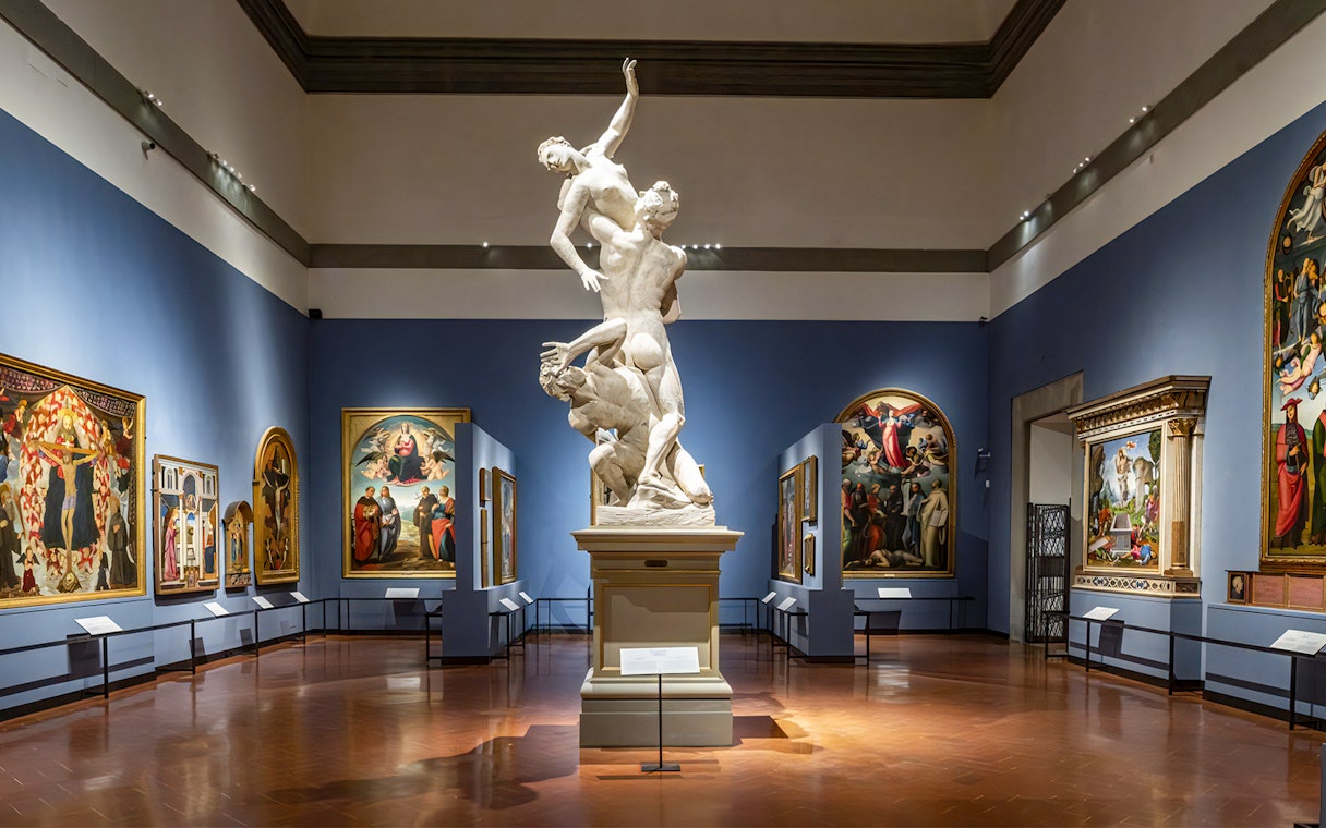 Accademia Gallery interior with sculptures and Renaissance paintings, Florence walking tour.