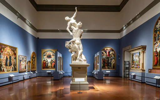 Accademia Gallery interior with sculptures and Renaissance paintings, Florence walking tour.