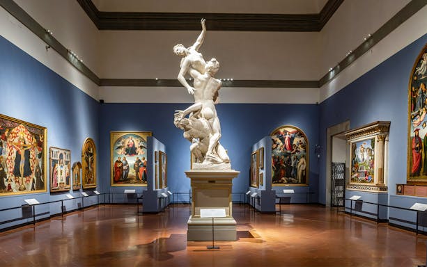 Accademia Gallery interior with sculptures and Renaissance paintings, Florence walking tour.