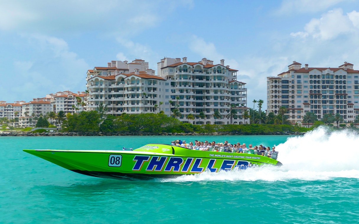 Speedboat tour in Miami passing luxury waterfront condos.