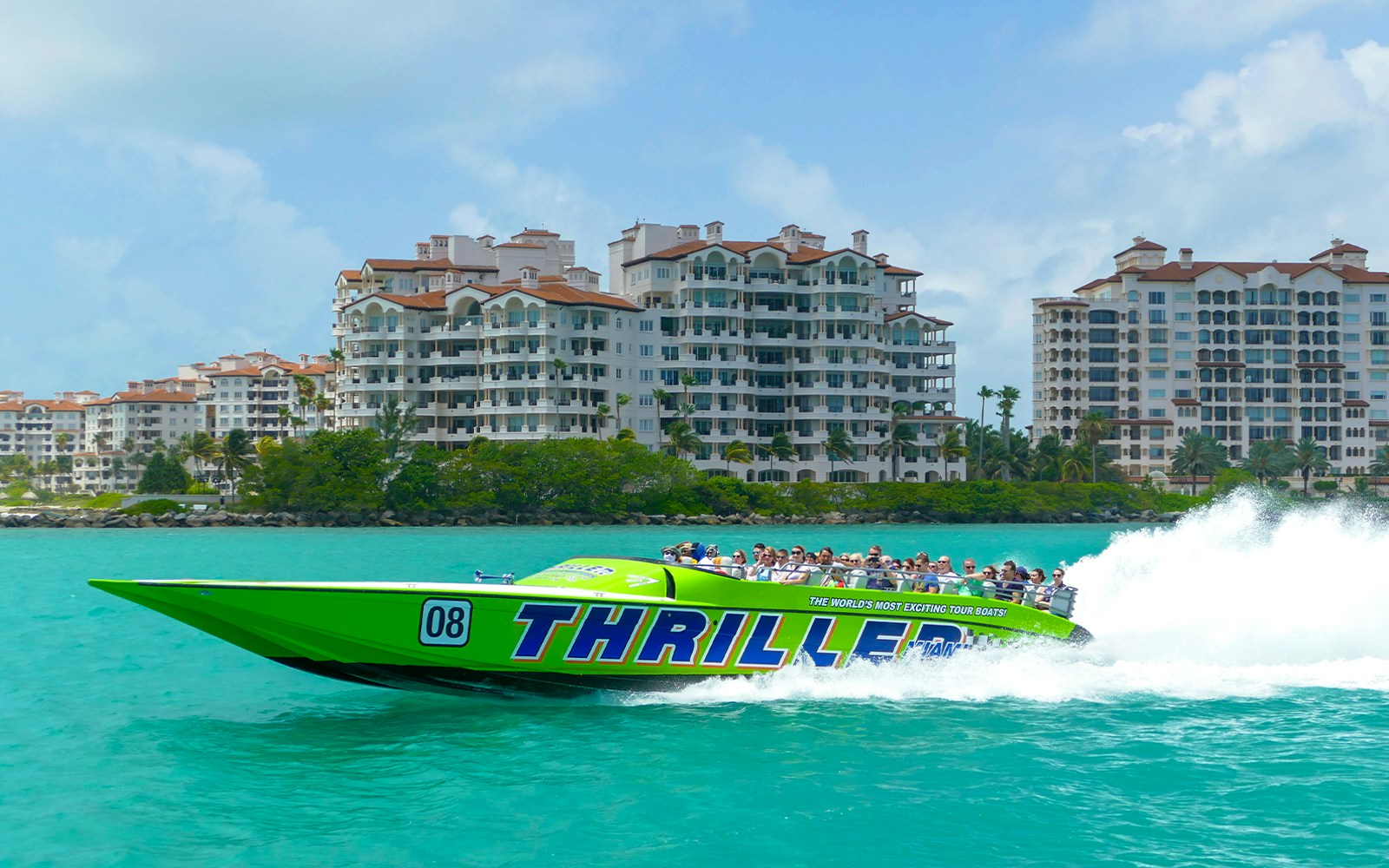Speedboat cruising past Miami skyline during sightseeing tour.