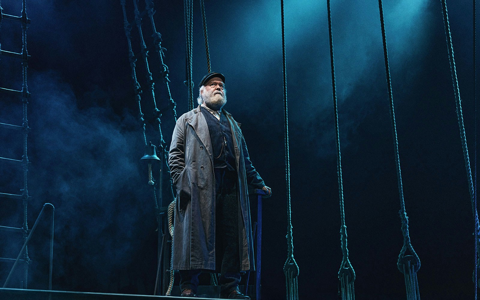 Man standing on a ship deck surrounded by ropes, part of the "Swept Away" tour experience.